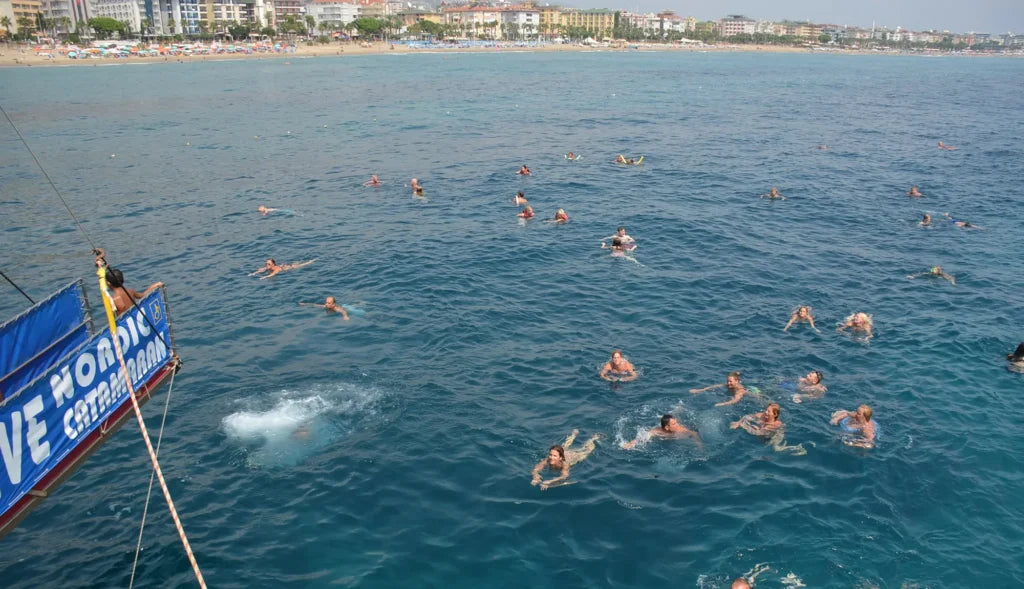 Alanya Catamaran Boat Tour with swimming breaks, music, sea views and Mediterranean coastline